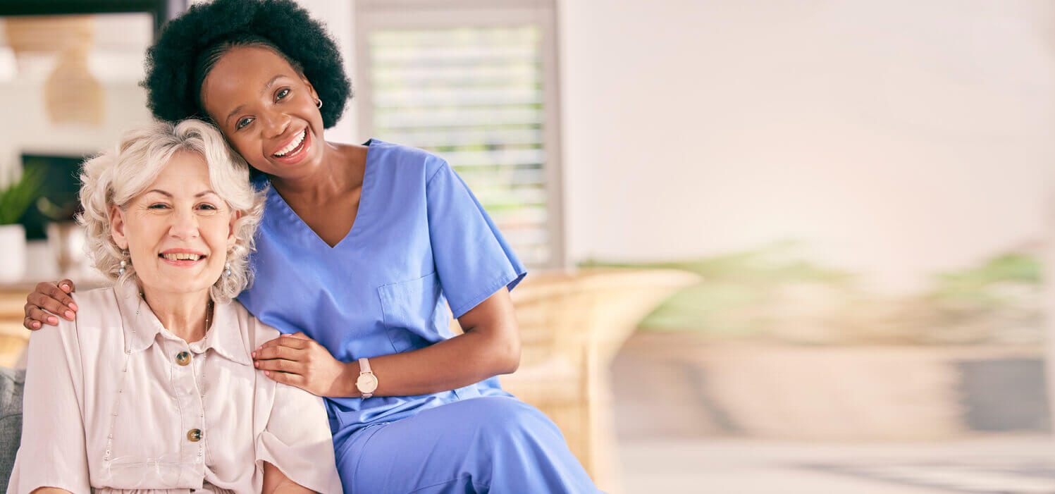 Happy senior woman and a caregiver during an hospice care at home.