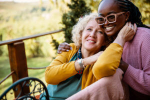 A senior woman undergoing rehabilitation, with the full-time care of a younger female at home.